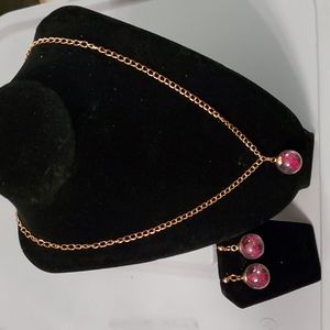 Goldtone chain necklace with dried flowers in clear charm